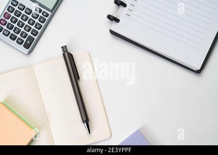 Topview of notebook with pen, calculator and sticky note Stock Photo
