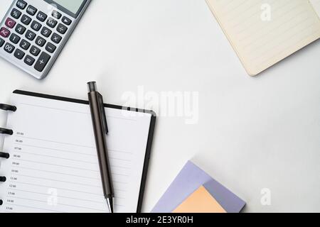 Topview of notebook with pen, calculator and sticky note Stock Photo