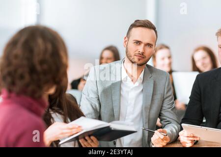 close up. brooding entrepreneur sitting at office Desk Stock Photo