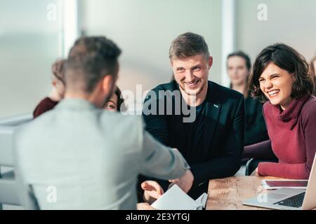 young people shaking hands at an office meeting Stock Photo