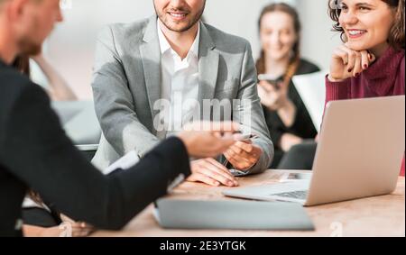 working group is discussing something while sitting at your Desk Stock Photo