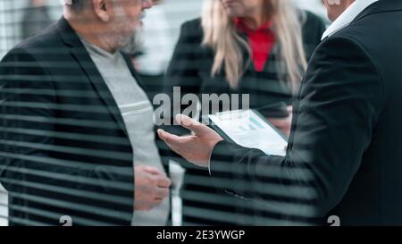 close up . business people talking standing in the office. Stock Photo
