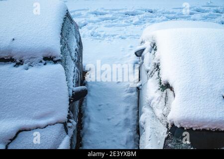 View from above of two cars covered in thick snow Stock Photo