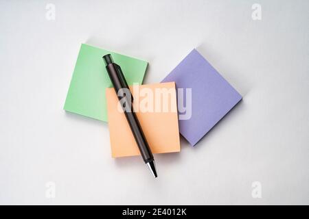 Topview of sticky note and pen on white surface Stock Photo