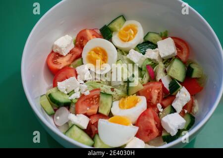 Close-up of a bowl of tomato and egg salad from above Stock Photo