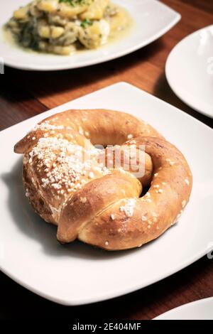 vegan dairy-free organic german traditional pretzel bread on wood table Stock Photo