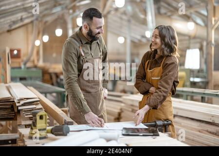 Two carpentry workers at the manufacturing Stock Photo