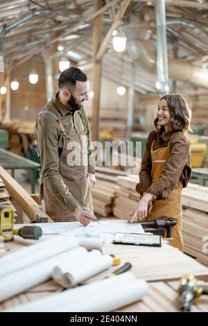 Two carpentry workers at the manufacturing Stock Photo