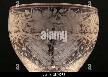Close up detail of the bowl on a mid Victorian , cut and engraved with grape vine , wine glass. Stock Photo