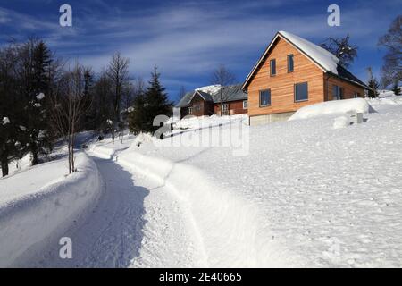 Winter in Poland. Rural road in Zywiec Beskids mountains (Beskid Zywiecki) near Milowka. Stock Photo