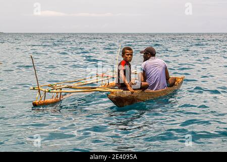 Outrigger Canoe in front of the True North at Panasia Island, Papua New Guinea Stock Photo