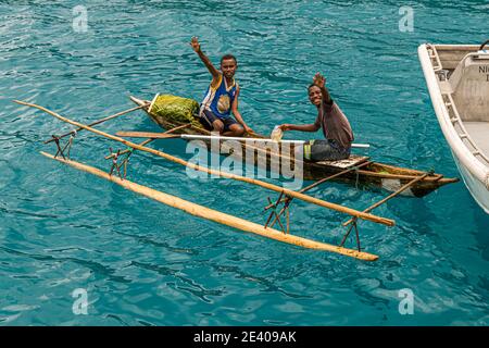 Outrigger Canoe in front of the True North at Panasia Island, Papua New Guinea Stock Photo
