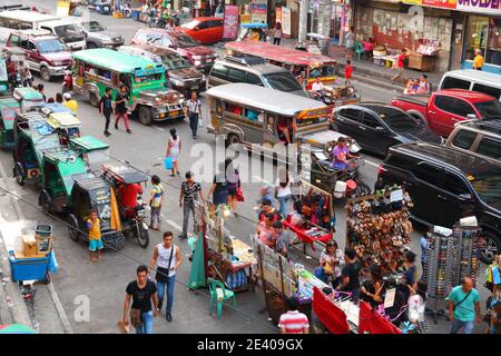 MANILA, PHILIPPINES - NOVEMBER 25, 2017: People drive in heavy traffic in Manila city, Philippines. Metro Manila is one of the biggest urban areas in Stock Photo