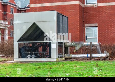 Horizontal close-up shot of a large exterior commercial HVAC unit for a residential complex. Stock Photo