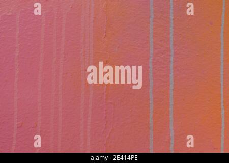 Plastered painted wall background with colorful drips, flows, streaks of paint and paint sprays Stock Photo