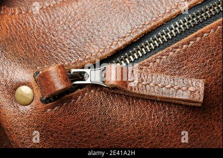 Brown leather zip lock on bag macro close up view Stock Photo