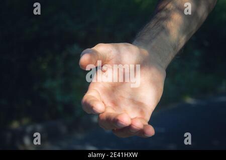 young man gives a hand for help Stock Photo