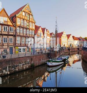 Old town of Stade, historic merchant and warehouse houses at the Hanseatic harbor with the sailing ship Willi, Germany, Lower Saxony, Stade