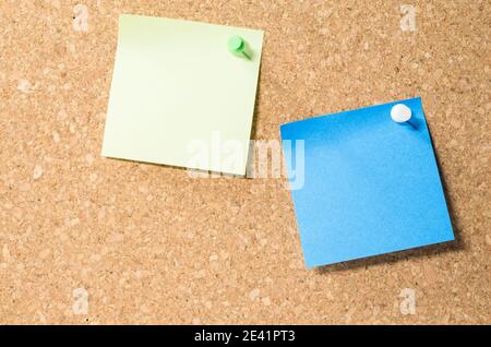 View of two blank post-it notes on a corkboard with copy space Stock Photo