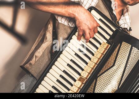 Accordionist plays accordion. Close-up photo with soft selective focus Stock Photo