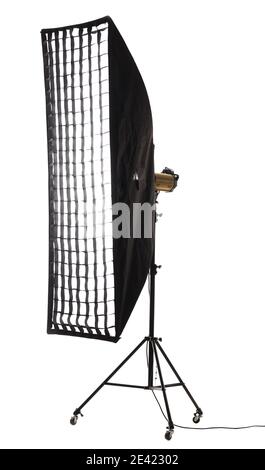 Flash light with strip softbox and grid stand with wheels. Studio lighting equipment isolated on white background. Stock Photo