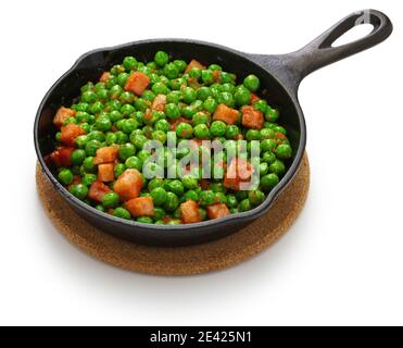 fresh green peas with ham in skillet isolated on white background Stock Photo