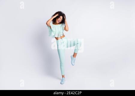 Full length body size photo of young beautiful female mulatto dancing in sunglass isolated on grey color background Stock Photo