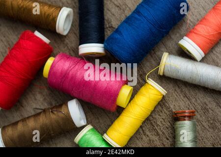 Many different colorful threads on a table in a tailor shop Stock Photo