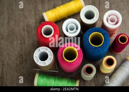 Many different colorful threads on a table in a tailor shop Stock Photo