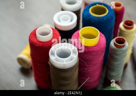 Many different colorful threads on a table in a tailor shop Stock Photo