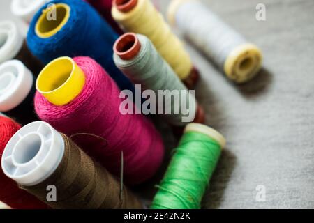 Many different colorful threads on a table in a tailor shop Stock Photo