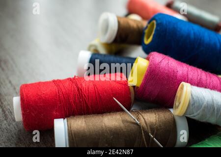 Many different colorful threads on a table in a tailor shop Stock Photo