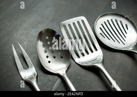Metal cookware on a black wooden table Stock Photo