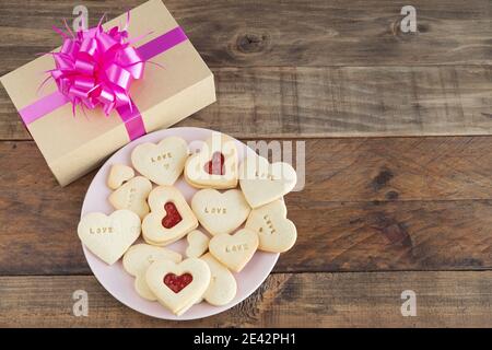 Dish with heart-shaped cookies on a wooden base. Concept Valentine's Day, Mother's Day, anniversary and decorations. Copy space Stock Photo