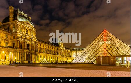 Inner Court and Pyramid at the Louvre Museum at night in Paris, France