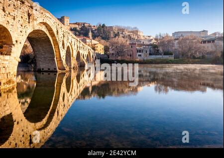 The old bridge and the Saint-Nazaire cathedral and their perfect reflection in Béziers in the Hérault in Occitanie, France. Stock Photo