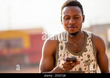 young african man uses his phone Stock Photo