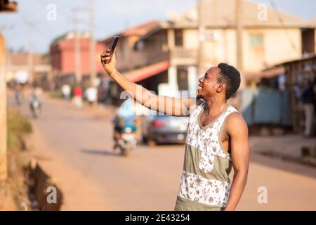 young black man takes a selfie with his phone Stock Photo