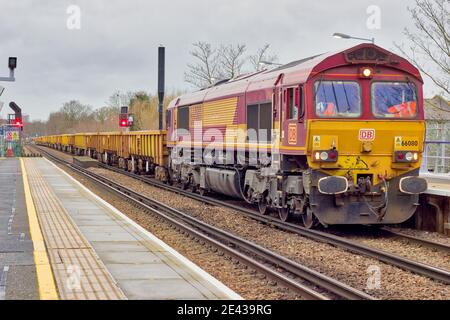 Class 66 Number 66080 loaded ballast wagons at station waiting for signal clearance on south-eastern railway network line, south London, England Stock Photo