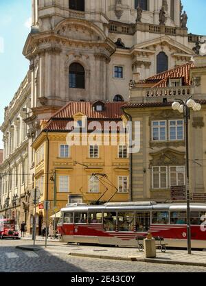 Prague, Czech Republic - August 2018: Tram running between buildings in the centre of Prague. Stock Photo