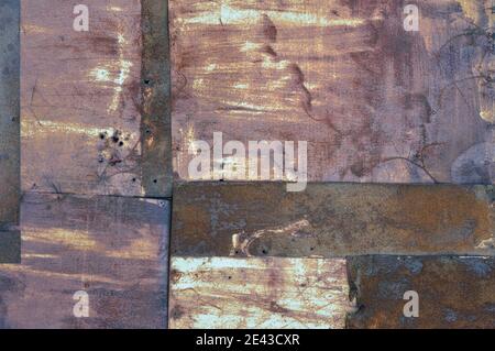 Old aged weathered rusty corroded coat iron sheets texture pattern, multiple horizontal rusted corroding grunge metal patch plates, rustic background Stock Photo