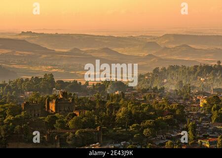 Beautiful sunrise over Gondar with view to castle and surrounding hills, orange sky, Ethiopia Stock Photo