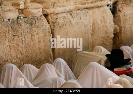 Covered in prayer shawls, ultra-orthodox Jewish men of the Cohanim priestly caste participate in a blessing during the Jewish holiday of Passover, in front of the Western Wall, Judaism's holiest site, in Jerusalem's Old City, Sunday, April 12, 2009. The Cohanim, believed to be descendants of priests who served God in the Jewish Temple before it was destroyed, perform a blessing ceremony of the Jewish people three times a year during the festivals of Passover, Shavuot and Sukkot.. Photo by Olivier Fitoussi /ABACAPRESS.COM Stock Photo