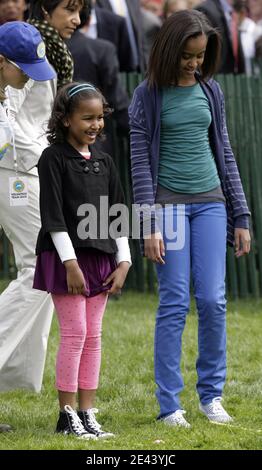 U.S. President Barack Obama's daughters Sasha and Malia walk with ...