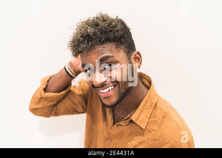 Handsome young bearded hipster black guy with curly hair and looking at camera Stock Photo