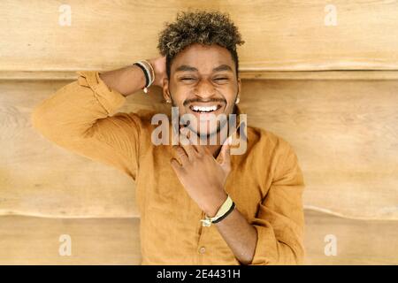 Handsome young bearded hipster black guy with curly hair and looking at camera Stock Photo