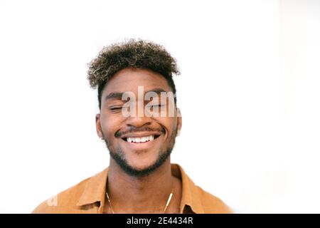 Handsome young bearded hipster black guy with curly hair Stock Photo