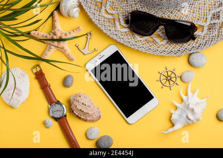 Phone mockup on sand among seashells and souvenirs Stock Photo