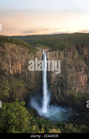 Spectacular aerial view of powerful Wallaman Falls flowing through rocky cliff in Girringun National Park covered with lush tropical vegetation in Que Stock Photo