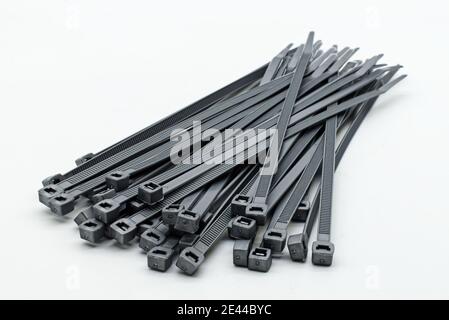 Grey plastic cable ties isolated on a white background Stock Photo